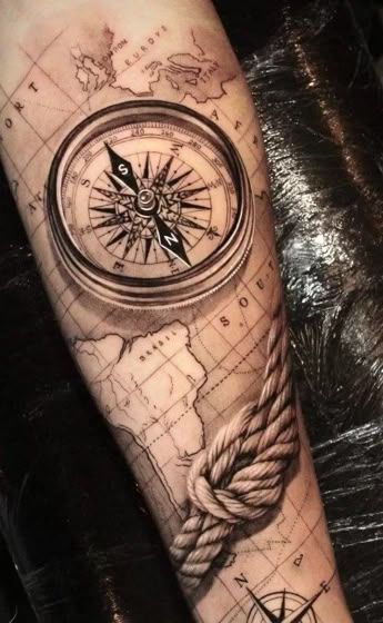 a man's arm with a compass and rope tattoo on the forearm, in black and white