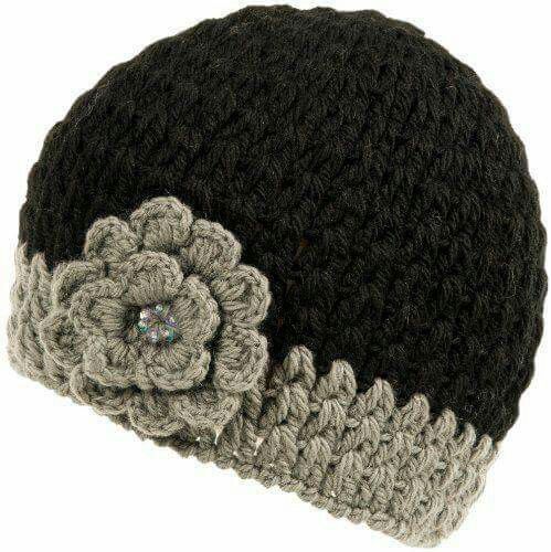 a crocheted beanie with a flower on the side and a button in the middle