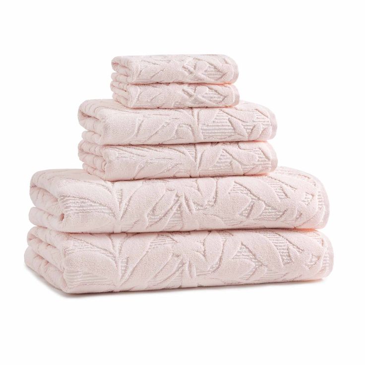 four pink towels stacked on top of each other