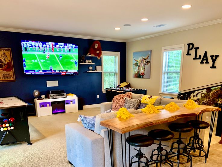 a living room filled with furniture and a flat screen tv mounted to the side of a wall