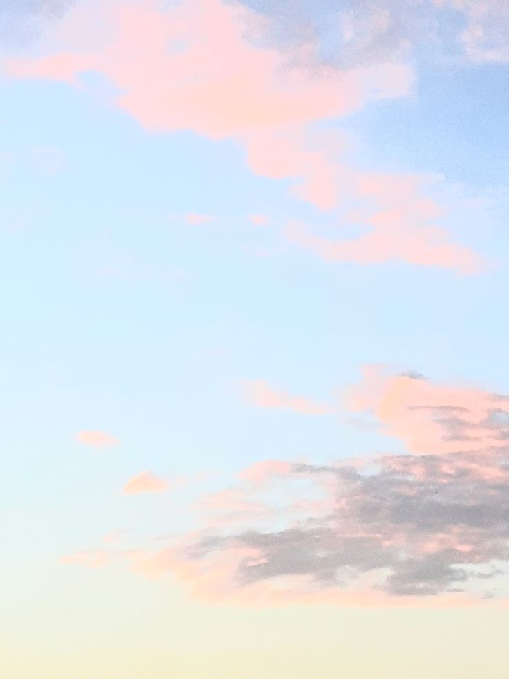 two airplanes are flying in the sky at sunset or dawn with pink clouds above them