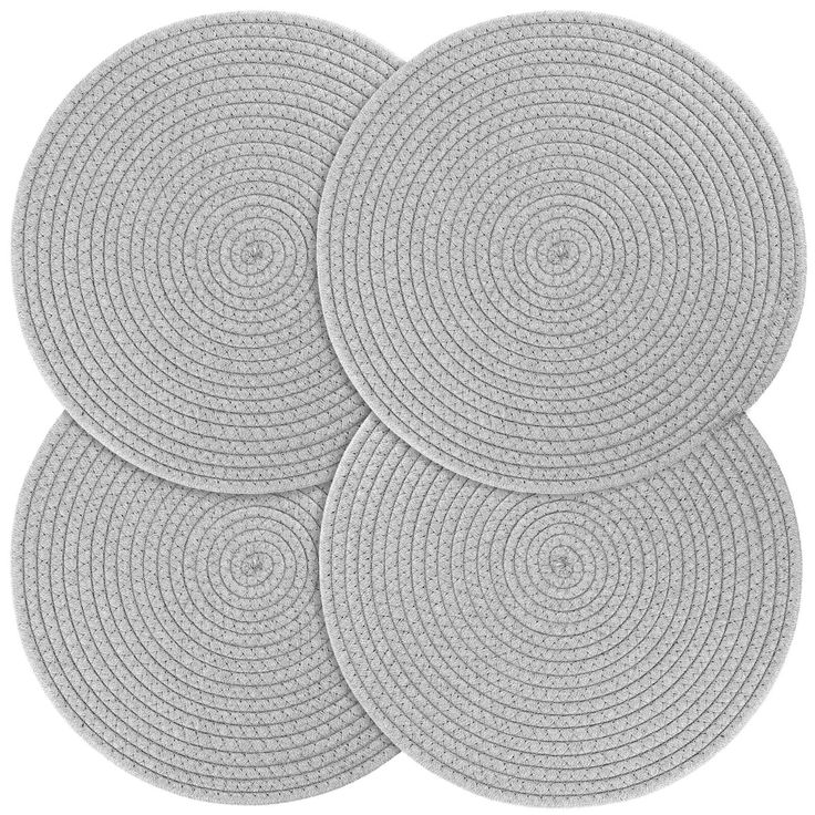 four round rugs in white on a white background