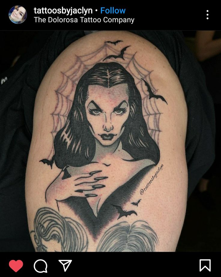 the tattoo artist is showing off his tattoos on her arm and shoulder, which features a woman's face