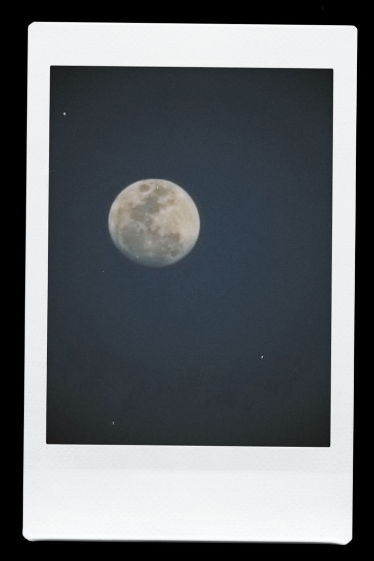 a polaroid photo of the full moon