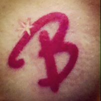 the word b is written in red ink on top of a woman's shoulder