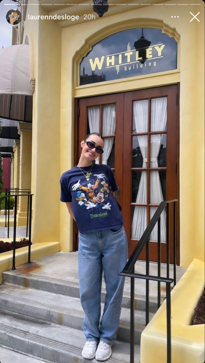 a man standing in front of a door with his hand on his head and wearing sunglasses