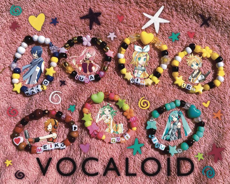 various bracelets and charms are laid out on a pink blanket with the word vocaoid written across them