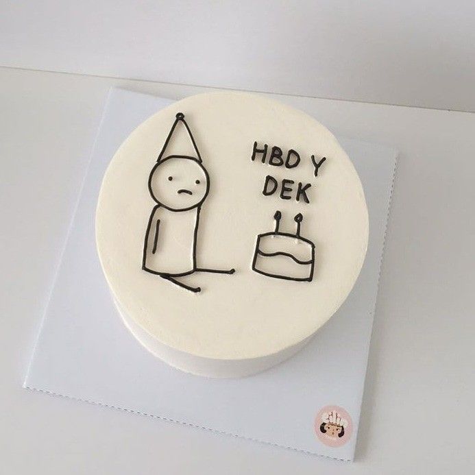 a white cake with a drawing of a man holding a cake on top of it