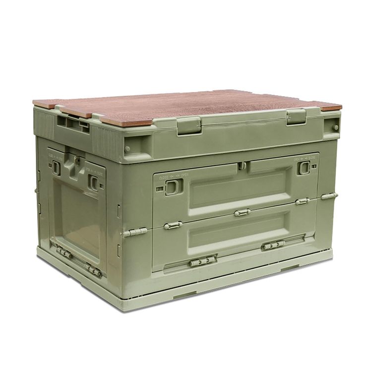 a large green box sitting on top of a white floor next to a red lid