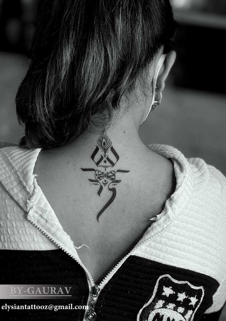 a woman with a tattoo on her neck