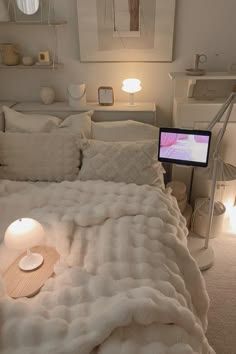 a bed with white sheets and pillows in a room