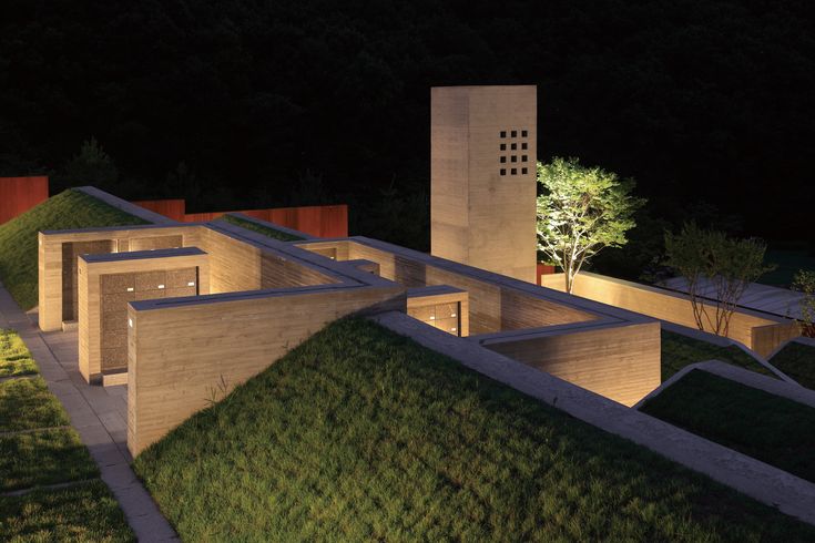 an aerial view of a building with grass on the roof