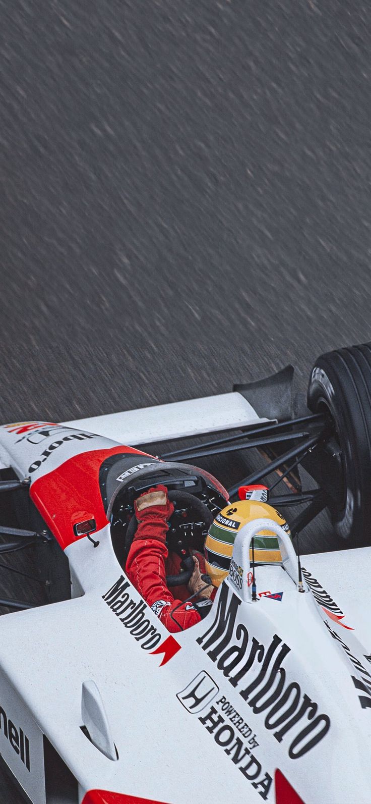 a man driving a race car on a wet track