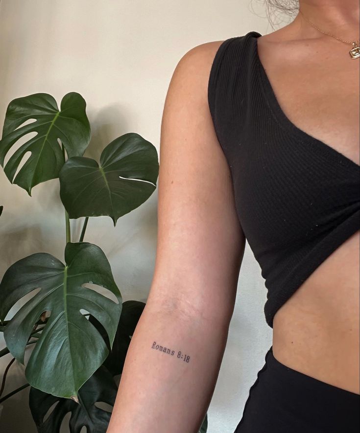 a woman with a small tattoo on her arm