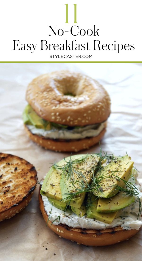 two bagel sandwiches with cucumber and dill on them are sitting next to each other