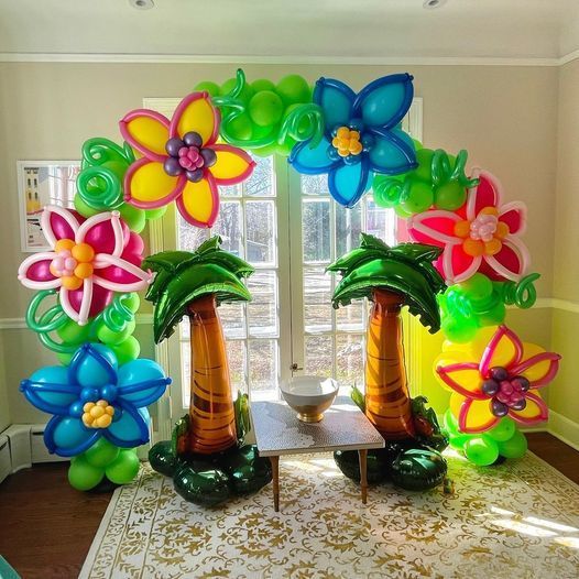 an arrangement of balloons in the shape of palm trees and flowers