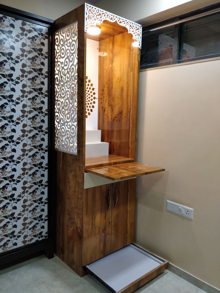 a wooden cabinet with an open door on the side in a room that has patterned walls and flooring