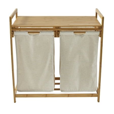 two white laundry hampers sitting next to each other on a wooden rack with canvas curtains