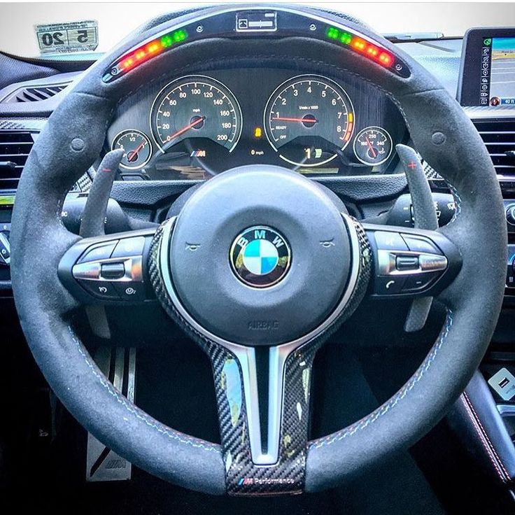 the steering wheel and dashboard of a bmw car