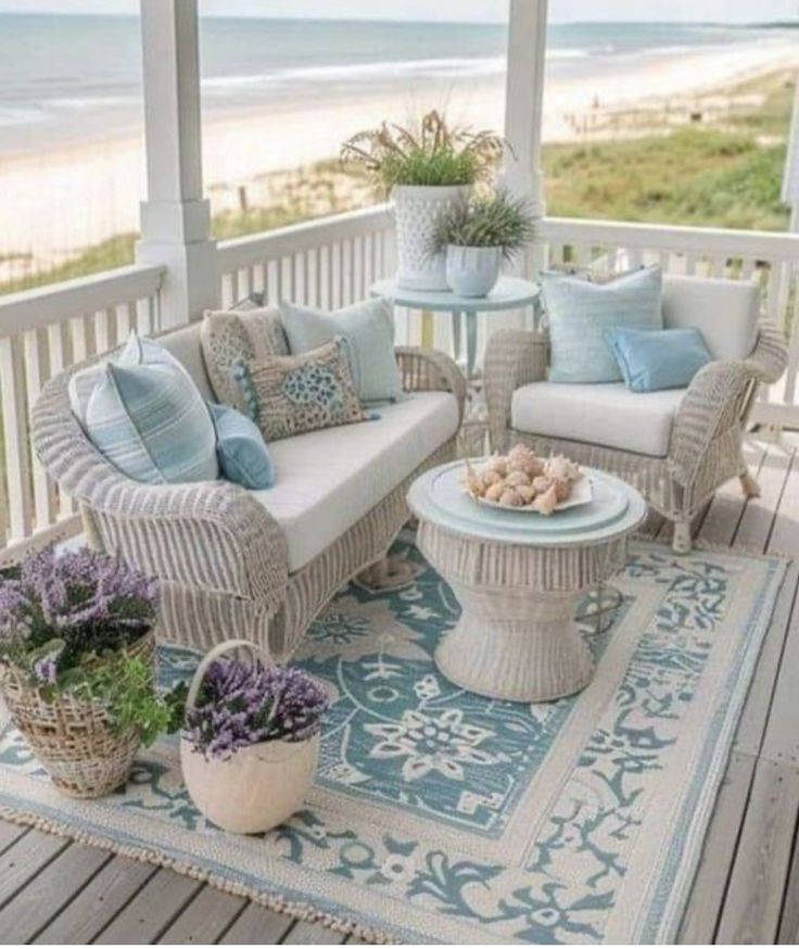 a porch with wicker furniture and blue pillows