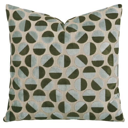 a green and blue pillow with circles on it