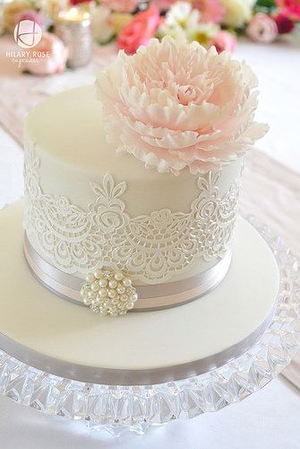 there is a white cake with pink flowers on it