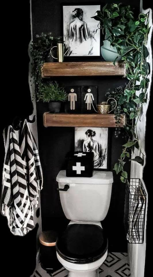 a black and white bathroom with shelves above the toilet, plants on the ledges