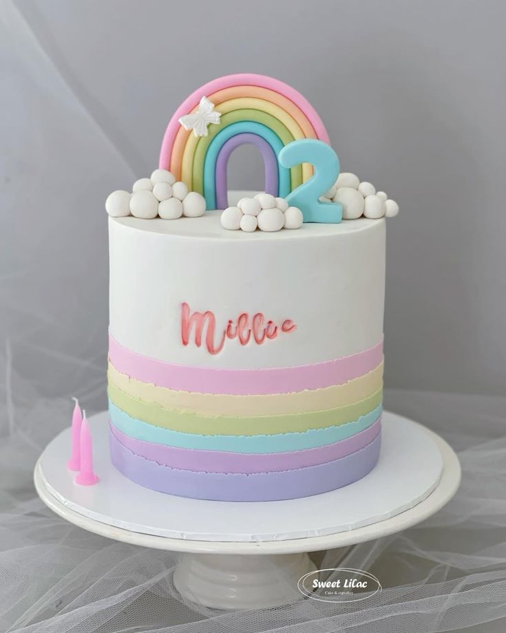 a birthday cake decorated with rainbows and stars