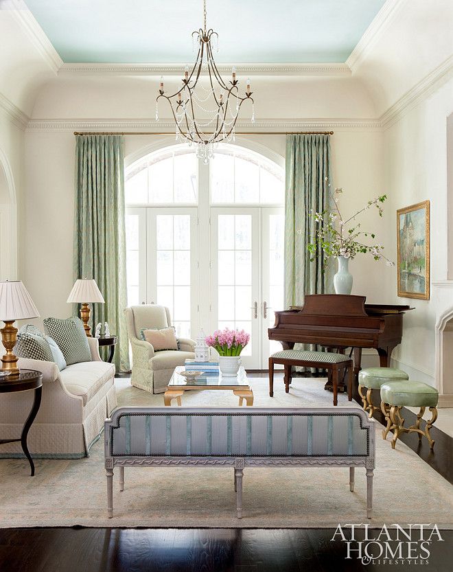 a living room filled with furniture and a chandelier