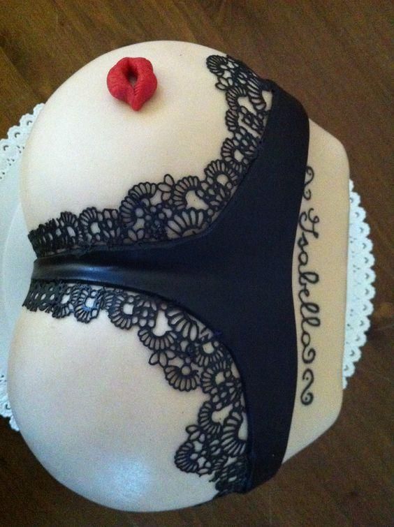 a white cake with black lace and a red heart on top