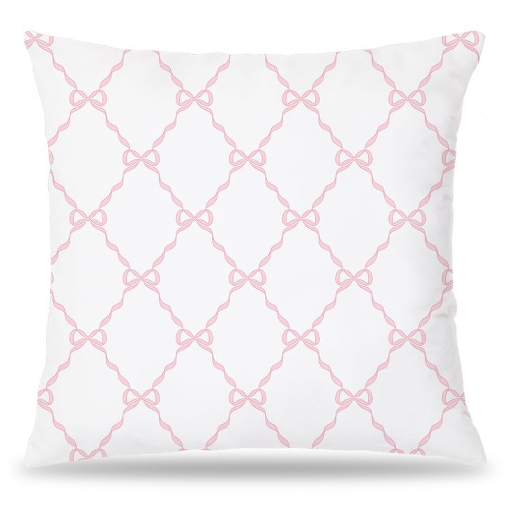 a white and pink pillow with an intricate design on the front, along with a light pink border