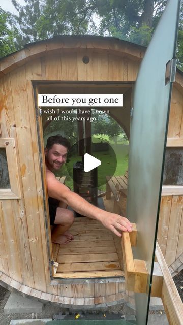 a man is opening the door to a wooden structure