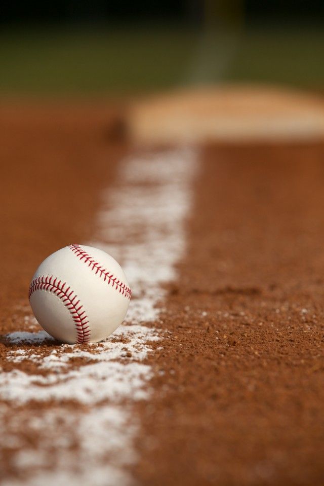 a baseball sitting on top of a baseball field