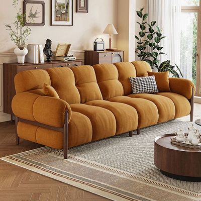 a living room scene with focus on the couch and coffee table in the foreground