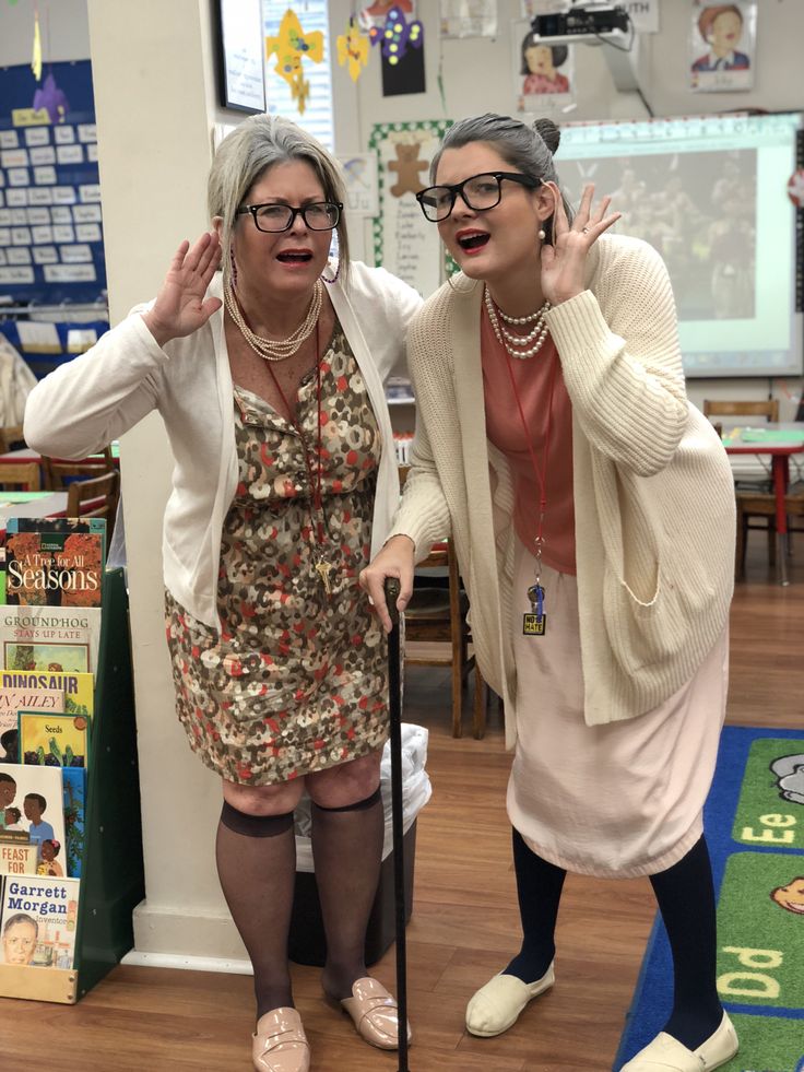 two older women standing next to each other in front of a book shelf with books on it