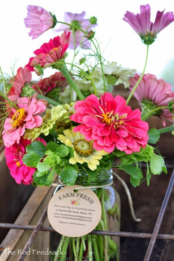 a mason jar filled with pink and yellow flowers