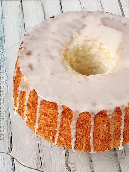 a frosted cake sitting on top of a glass plate