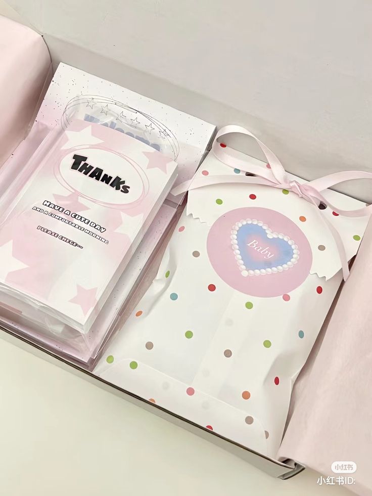 an open box with a pink bow on the top and polka dot design in it