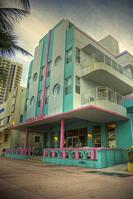 a multi - colored building with balconies on the top floor