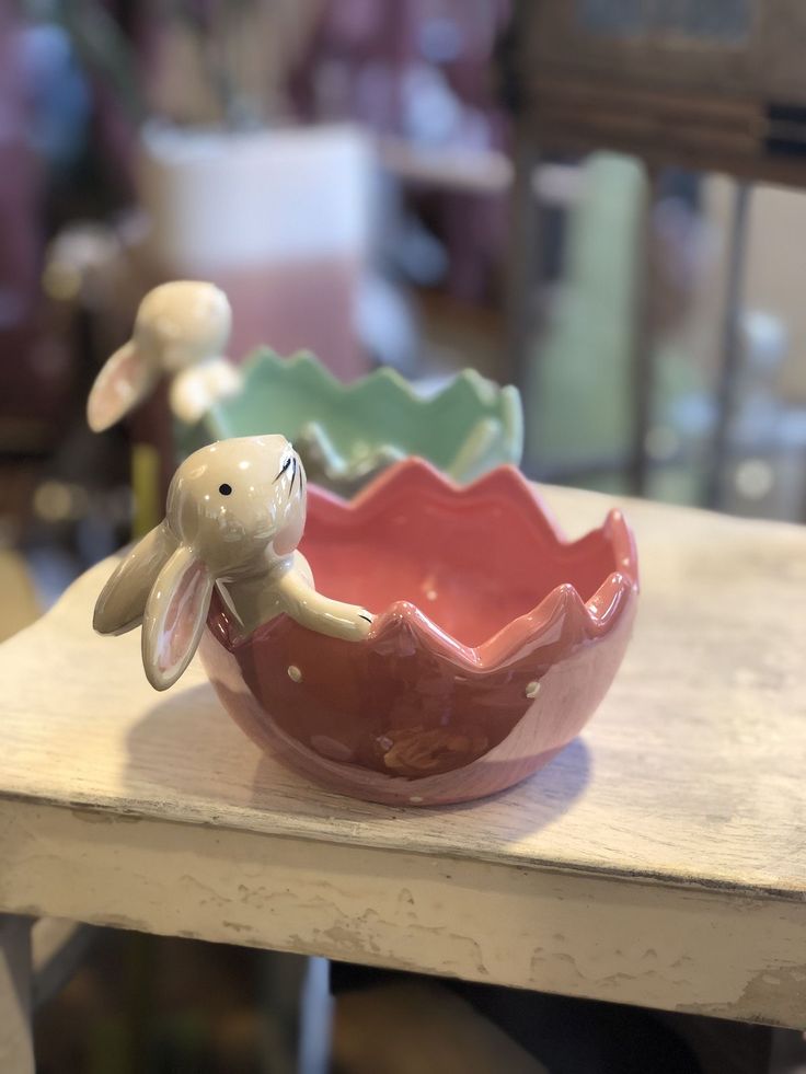 a ceramic bowl with a bunny in it on a table