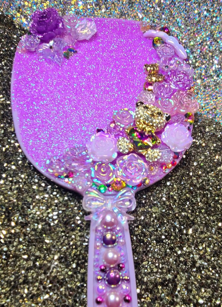 a purple mirror sitting on top of a glitter covered floor