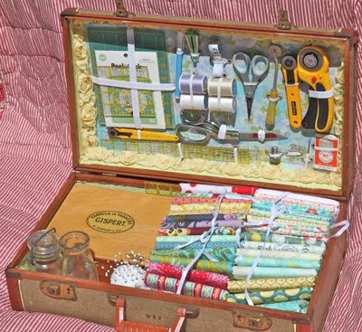 an open suitcase filled with lots of crafting supplies