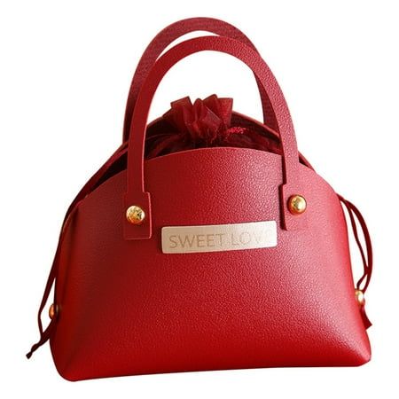 a red handbag with a bow on the top and name tag attached to it