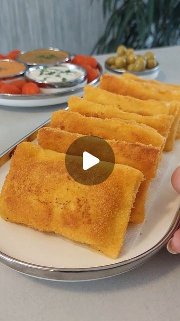 a person is holding a plate with food on it and there are other plates in the background