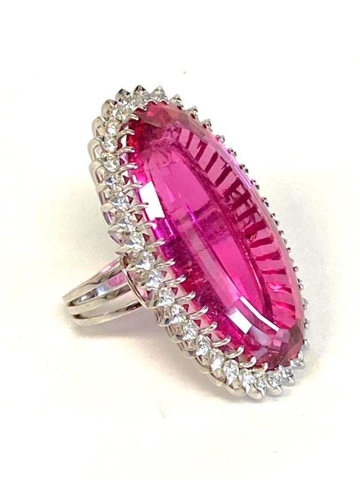 Platinum Pink Tourmaline & Diamond Cocktail Ring DescriptionPlatinum Ring; 1 Oval Pink Tourmaline 31.11 Carat; 37 Round Brilliant Cut Diamonds 1.48 Carat Total Weight, SI-1, I-J; Finger Size 5 1/2; 19.7 Grams. #BarbieRing#Barbie#BarbiePink Payment All payments must be made through PayPal, NO EXCEPTIONS. We cannot accept payment plans. We do not offer Layaway. Shipping We ship via USPS Registered Mail, Return Receipt in order to provide tracking and insured delivery, which usually takes 5-7 days Barbie Ring, Pink Diamonds, Diamond Cocktail Ring, Barbie Life, Diamond Cocktail Rings, Bratz Doll, Platinum Ring, Pink Velvet, Pink Diamond