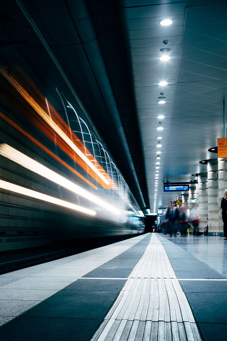 people are waiting for their train at the station to arrive and depart in the evening