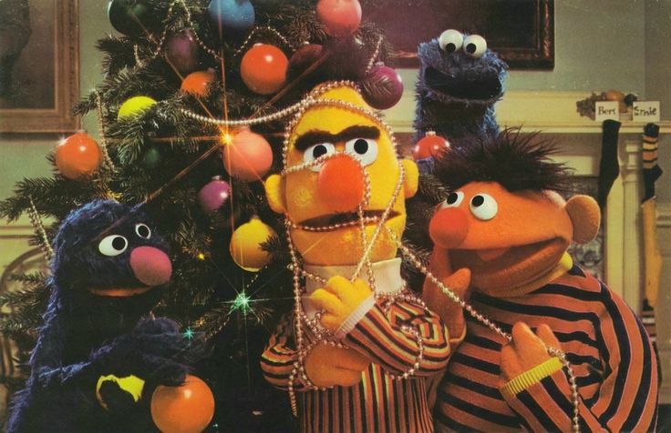 the muppets are standing in front of a christmas tree with balloons on it