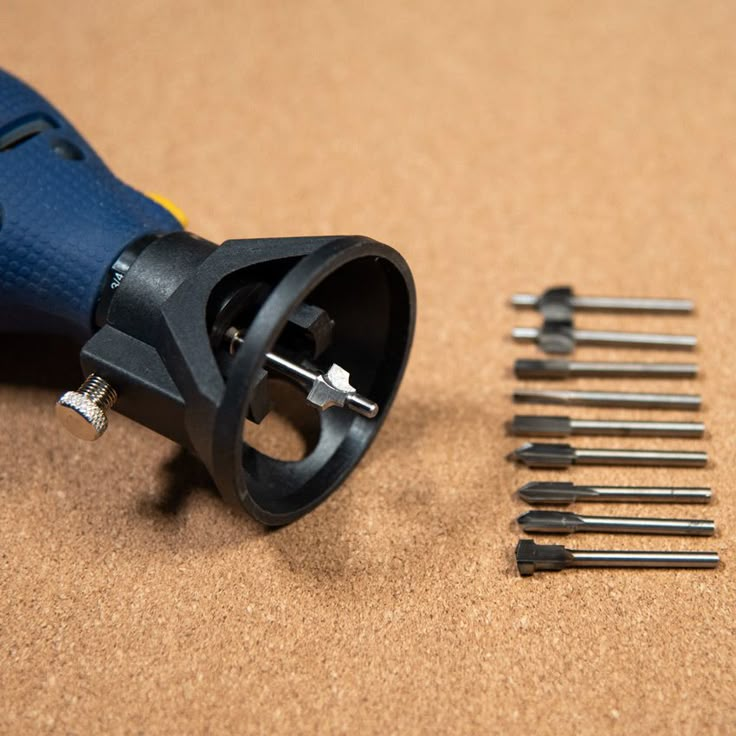 the tools are laying next to each other on the table with some screws in it