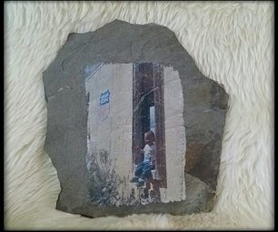 a rock with an image of a child standing in front of a door on it