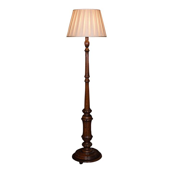 a wooden floor lamp with a white shade